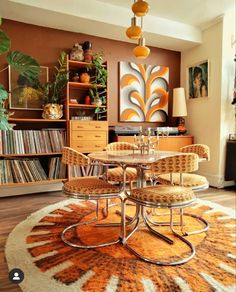 a living room filled with furniture and a round table surrounded by chairs on top of a rug