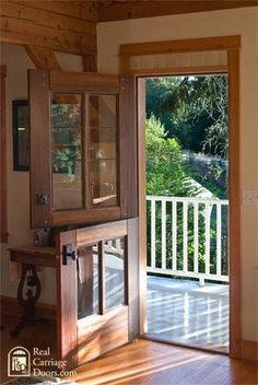 an open door leading to a deck and garden