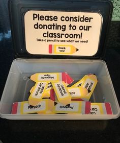 there is a plastic container filled with yellow and red eraser labels that say please consider donaing to our classroom