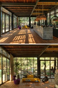 the inside and outside of a house with wood flooring, glass walls and large windows