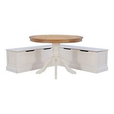 a white table with two drawers underneath it and a round wooden table on the other side