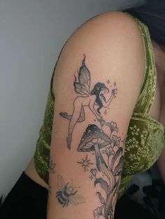 a woman with a fairy tattoo on her arm