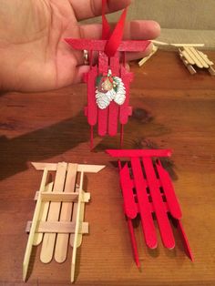 someone is making popsicle ornaments out of popsicle sticks