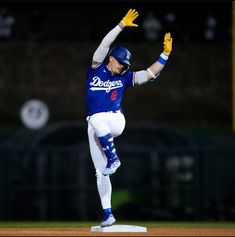 a baseball player with his arms in the air