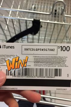 someone is holding up a itunes gift card in front of a shopping cart with the word win on it