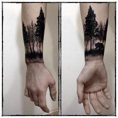 a man's arm with trees on it and his hand in the foreground