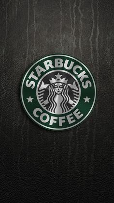 the starbucks logo is shown on a black leather surface