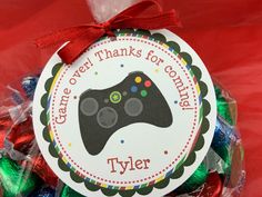 a round ornament with a video game controller on it, surrounded by candy