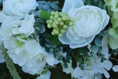 a bouquet of white flowers and green leaves