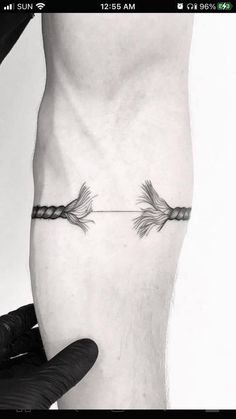 an arrow tattoo on the leg