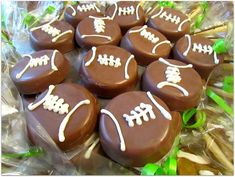 chocolate footballs with white frosting on them