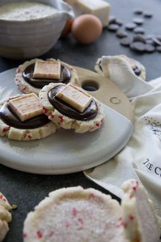 some cookies are on a plate with chocolate and sprinkles