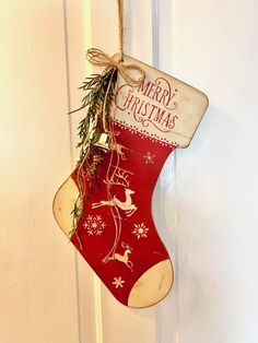 a red christmas stocking hanging from a door