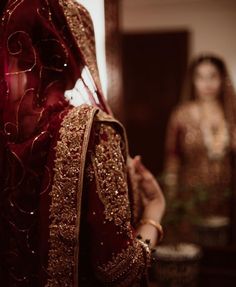 a woman in a red and gold outfit