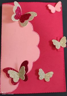 a pink card with glitter butterflies on the side and two smaller ones in the middle