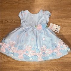 Light Blue Flower Dress. Size 12. Cuter Easter Dress! Brand New Cute Blue Dresses With Floral Applique, Cute Blue Dress With Floral Applique, Blue Floral Applique Dress For Dress-up, Light Blue Floral Applique Summer Dress, Blue Floral Print Playtime Dress, Cute Blue Floral Dress For Spring, Spring Princess Playtime Dresses, Cute Floral Dress For Spring, Spring Floral Pink Dress For Casual