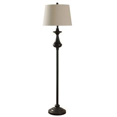 a floor lamp with a white shade on it's side and a black base