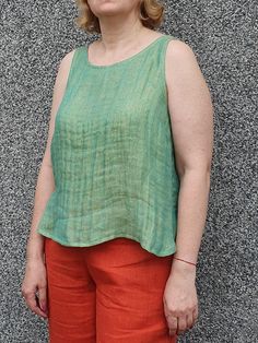 A green linen tank top crafted from high-quality breathable fabric. This top is perfect for warm days and mild evenings. The relaxed fit and sleeveless design offer comfort and freedom on movement while the subtle texture adds a touch of sophistication. Chest darts makes it more tailored. You can also like casual pants to match: https://debesyclothes.etsy.com/listing/1540334621 Composition & care instructions: 100% washed linen (flax), Lithuanian quality, medium weight 2 layers fabrics  Gentle m Linen Tank Top, Linen Tank, Top For Women, Top Sleeveless, Sleeveless Blouse, Medium Weight, Womens Clothing Tops, Breathable Fabric, Casual Pants