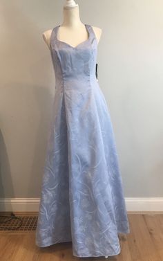 a blue dress on a mannequin head stand