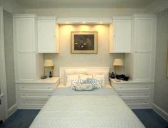 a white bed sitting in a bedroom next to two lamps