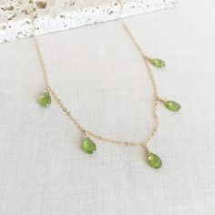 "This is a peridot drop necklace made of genuine high quality faceted peridot. There are gold filled ,sterling silver and 14kt gold chain you can choose from. Each necklace has 2\" extender. 14k gold necklace will be in single size without extender.This is a August birthstone necklace. Peridot jewelry is light weight and elegant. This green peridot is around 1 carats. The green stone necklace is great for layering with other gold necklaces. I pay attention to detail and pick the best quality per Green Drop-shape Birthstone Necklace, Green Teardrop Faceted Necklace, Green Faceted Briolette Necklaces, Green Faceted Briolette Necklace, Green Briolette Faceted Necklace, Peridot Briolette Necklace As Gift, Briolette Peridot Necklaces As Gift, Fancy Gold Necklace, Necklace Fancy