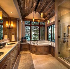 a large bathroom with two sinks and a walk in shower