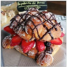 a pastry with strawberries and chocolate drizzled on top