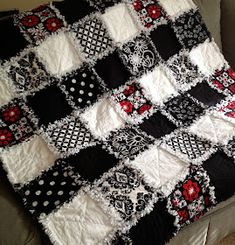 a black and white quilt sitting on top of a couch