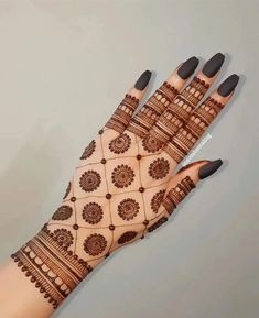 a woman's hand with henna on it