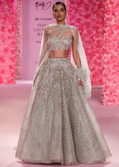 Powdery sage shimmer tulle structured lehenga accentuated with thread work and hand crystal beading, paired with bustier choli and draped tulle dupatta - highlight is the feather engulfed cuff on dupatta. Cocktail Lehenga, Shimmer Lehenga, Reception Outfit, Sharara Gharara, Royalty Aesthetic, Indian Bridal Fashion, Western Wedding, Wedding Service, Desi Fashion