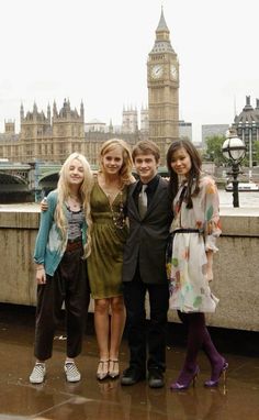 four young people posing in front of the big ben clock tower