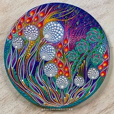 an artistically painted plate on a wooden surface