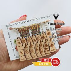 a hand holding some wooden earrings in front of a card with the words free shipping on it