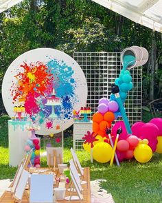 an outdoor birthday party with balloons and decorations