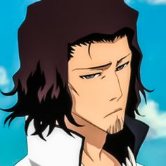 a man with long hair and blue eyes stares into the distance while wearing a white shirt