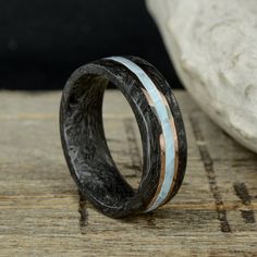 "Specifications: - 2.25mm Forged Carbon Fiber - .75mm Rose Gold (Or Metal of your choice) - 2mm Full Larimar - .75mm Rose Gold (Or Metal of your choice) - 2.25mm Forged Carbon Fiber The total width of this ring is 8mm, Comfort Fit What is Forged Carbon Fiber? This is an innovative material developed by Lamborghini that accentuates the beautiful marbled colors/patterns of Carbon Fiber while maintaining the high strength/durability of this material! We developed our own proprietary process to repl Forged Carbon Fiber, Opal Solitaire Ring, Triumph Daytona, Ring Styles, Custom Ring Designs, Rings Engagement, Aquamarine Stone, Handcrafted Rings, Stone Engagement Rings