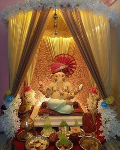 an elephant statue sitting on top of a table covered in food