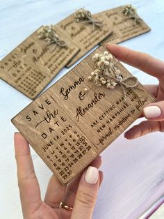 someone is holding up some wooden calendars with flowers on them, and the date has been changed