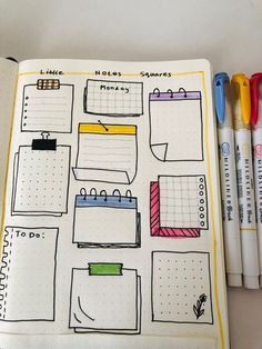 an open planner with notes and markers on it