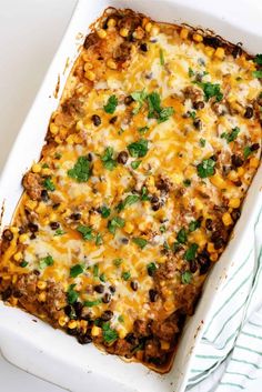 an enchilada casserole in a white baking dish