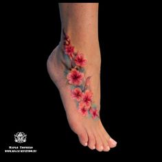 a woman's foot with flowers painted on it