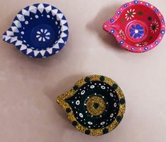 three decorative bowls sitting on top of a table