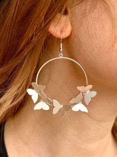 Make a statement with our bold Butterfly Hoop Earrings. These stylish dangling hoops feature a beautiful multiple butterfly design. Elevate your look with these eye-catching earrings. Size: 1.5" hoop Butterfly: 0.5" x 0.75" Elegant Spring Butterfly Jewelry, Spring Small Hoop Earrings, Spring Hoop Earrings With Ear Wire, Spring Small Hoop Earrings For Pierced Ears, Nickel Free Hoop Earrings For Spring, Nickel-free Hoop Earrings For Spring, Trendy Spring Dangle Hoop Earrings, Spring Trendy Dangle Hoop Earrings, Trendy Dangle Hoop Earrings For Spring