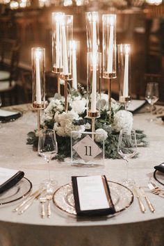 an elegant table setting with candles and flowers