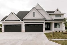 a large white house with two garage doors