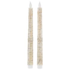 two white candles sitting next to each other