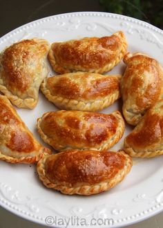 a white plate topped with lots of pastries