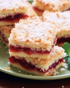 several pieces of cake on a plate with mint leaves