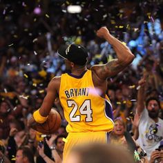 the basketball player is celebrating with confetti in front of his team's fans