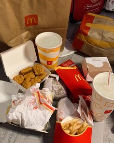 mcdonald's chicken nuggets, french fries and milkshake are on the table